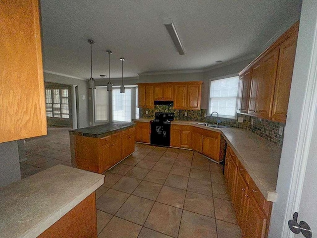 kitchen with stove, decorative backsplash, under cabinet range hood, a kitchen island, and a sink