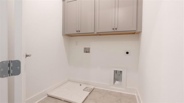7020 Cottage Grove Dr, Flowery Branch, GA 30542 - laundry area with washer hookup, electric dryer hookup, cabinet space, and tile patterned floors