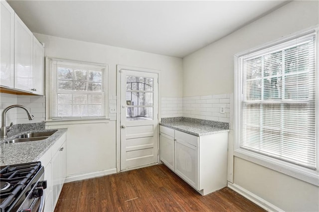 kitchen featuring white cabinetry, sink, dark hardwood / wood-style flooring, and tasteful backsplash