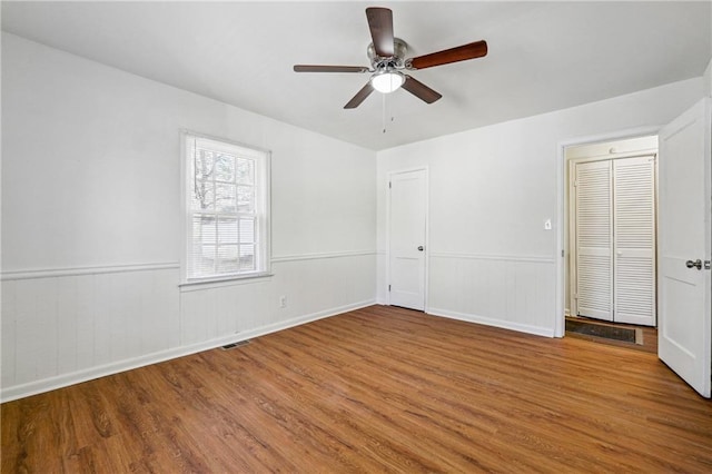 unfurnished room featuring wood-type flooring and ceiling fan