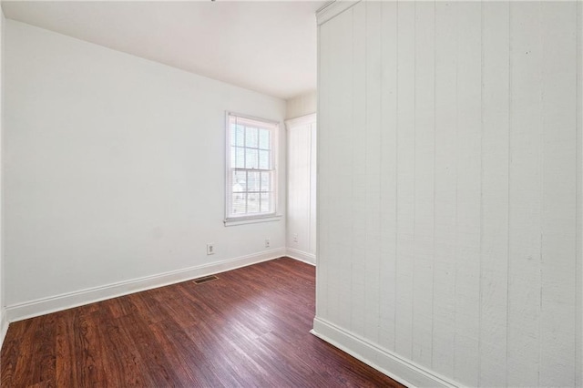 spare room with dark hardwood / wood-style floors