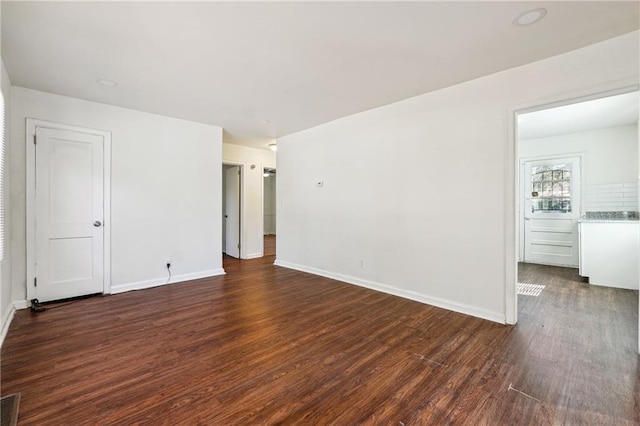 empty room featuring dark wood-type flooring