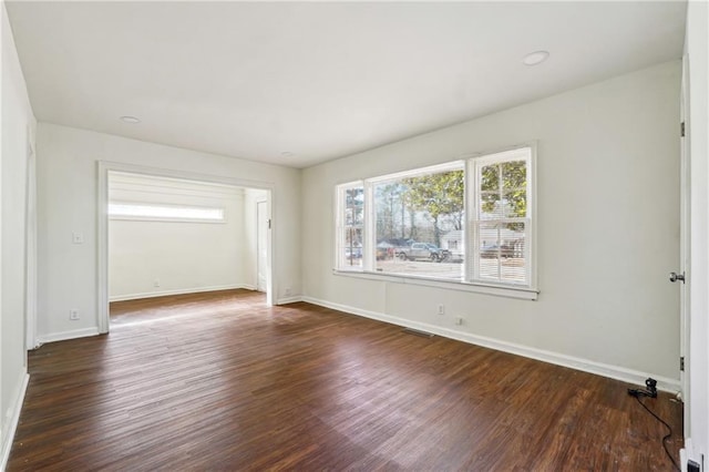 empty room with dark hardwood / wood-style floors