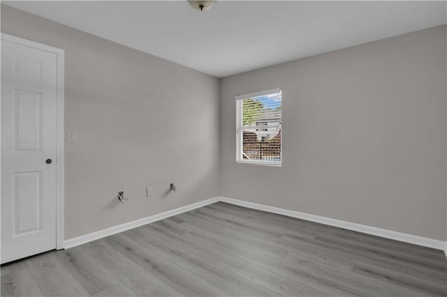 empty room with baseboards and wood finished floors