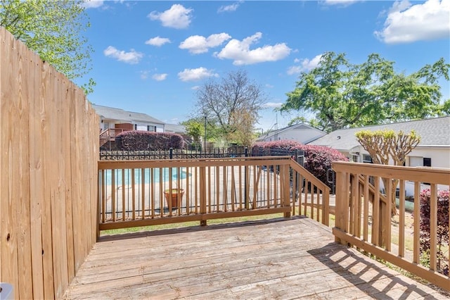 wooden deck featuring a fenced backyard