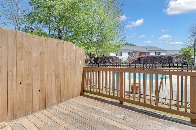 wooden terrace featuring fence