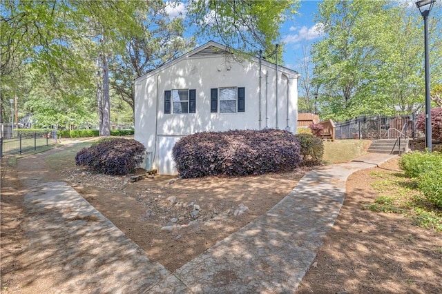 view of outbuilding with fence