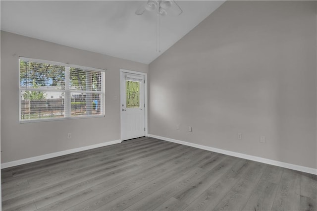 foyer entrance featuring ceiling fan, high vaulted ceiling, wood finished floors, and baseboards