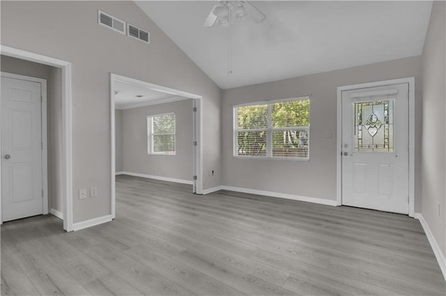 entrance foyer with baseboards, light wood-style flooring, visible vents, lofted ceiling, and ceiling fan