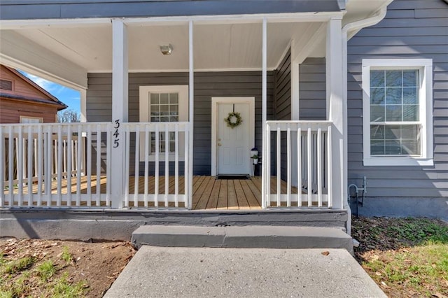 view of exterior entry featuring a porch