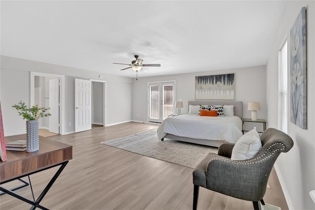 bedroom featuring baseboards, wood finished floors, a ceiling fan, and access to exterior