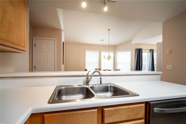 kitchen featuring vaulted ceiling, sink, decorative light fixtures, an inviting chandelier, and dishwasher