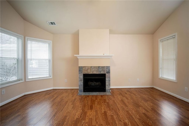 unfurnished living room featuring a fireplace, hardwood / wood-style flooring, and vaulted ceiling