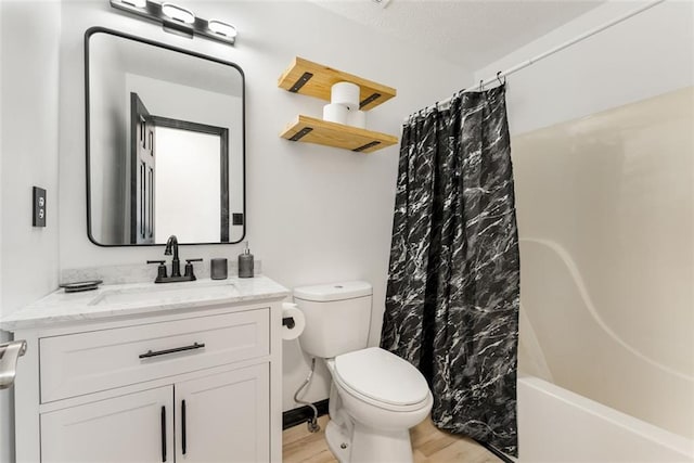 full bath with vanity, shower / bath combo with shower curtain, wood finished floors, and toilet