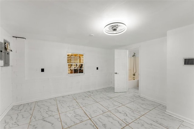 unfurnished room featuring marble finish floor, electric panel, visible vents, and baseboards