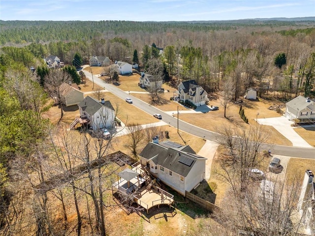 birds eye view of property featuring a forest view