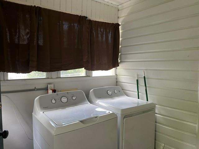 washroom featuring cabinets and washer and dryer