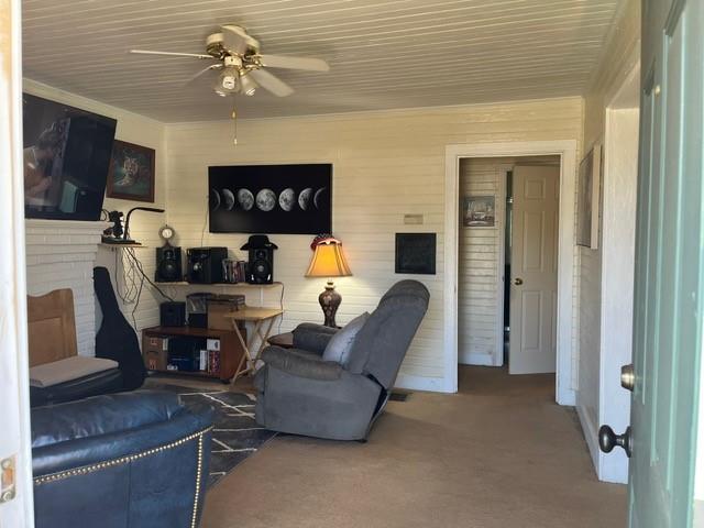 living room with ceiling fan and carpet flooring