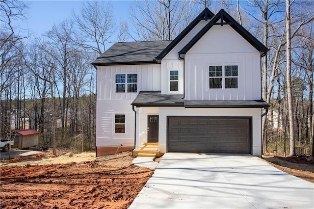 modern inspired farmhouse with board and batten siding, entry steps, concrete driveway, and a garage