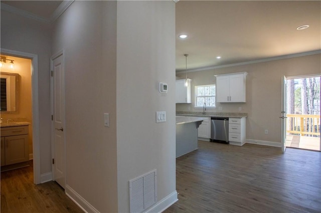 corridor featuring ornamental molding, visible vents, baseboards, and dark wood-style floors