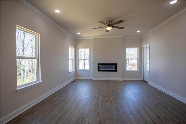 unfurnished living room with ornamental molding, plenty of natural light, and baseboards