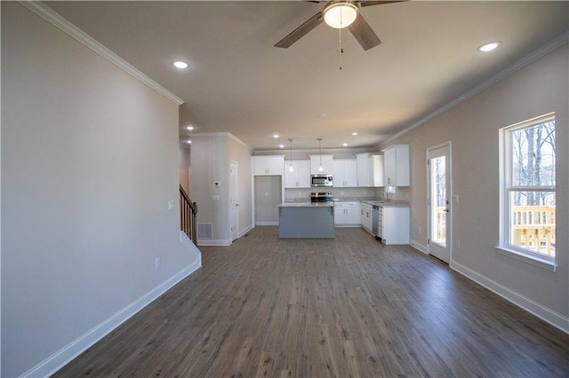 unfurnished living room with baseboards, stairway, dark wood finished floors, and crown molding