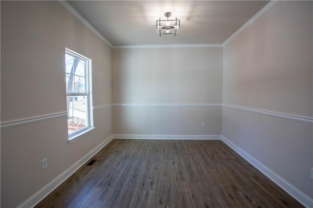 spare room with crown molding, visible vents, and baseboards