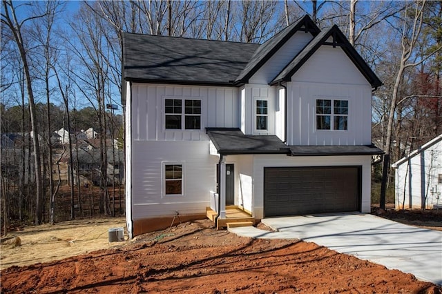 modern farmhouse style home featuring a garage, driveway, and board and batten siding