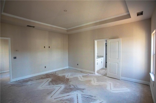 spare room with baseboards, visible vents, a tray ceiling, and ornamental molding