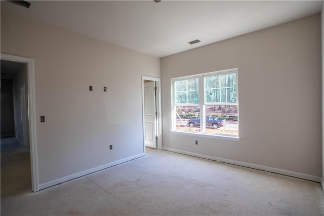 unfurnished room with baseboards and visible vents