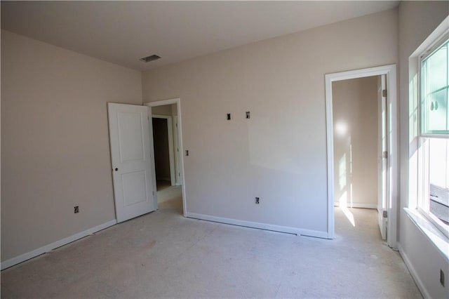 spare room featuring visible vents and baseboards