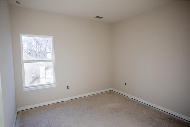 spare room with baseboards