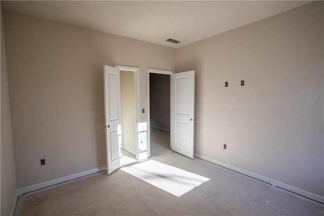 unfurnished bedroom featuring visible vents and baseboards