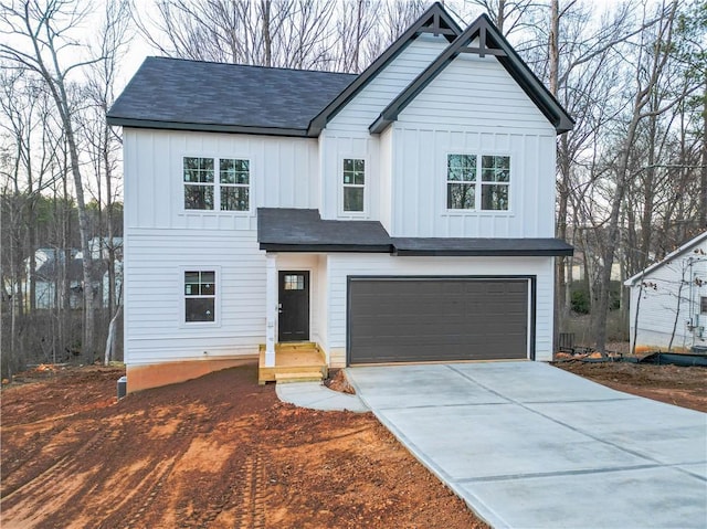 modern farmhouse featuring an attached garage, board and batten siding, and concrete driveway