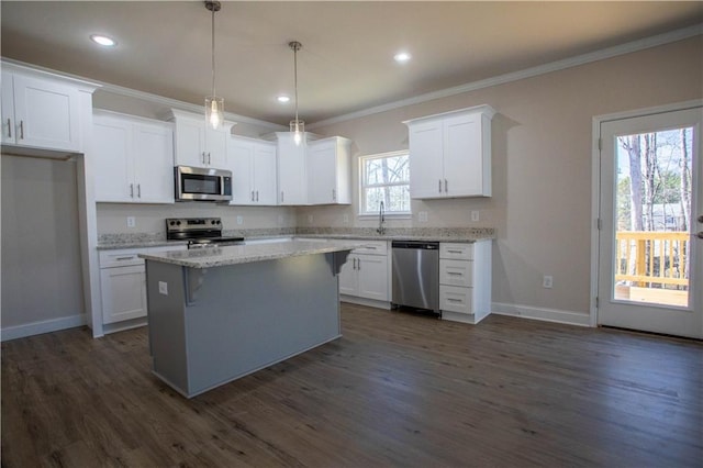 kitchen featuring appliances with stainless steel finishes, white cabinets, dark wood finished floors, and ornamental molding