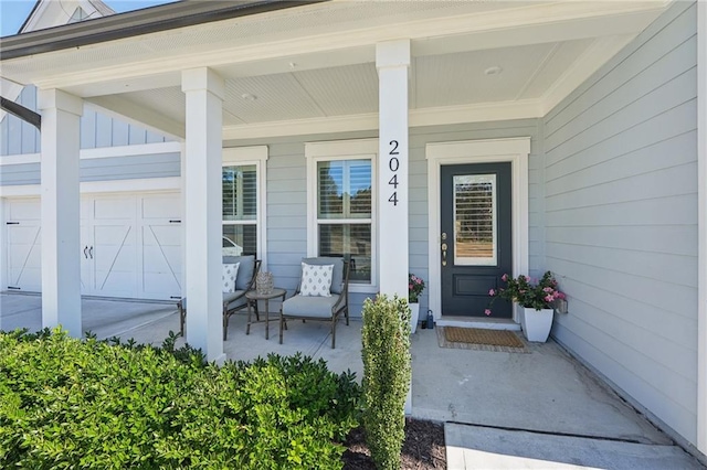 property entrance featuring a garage and a porch