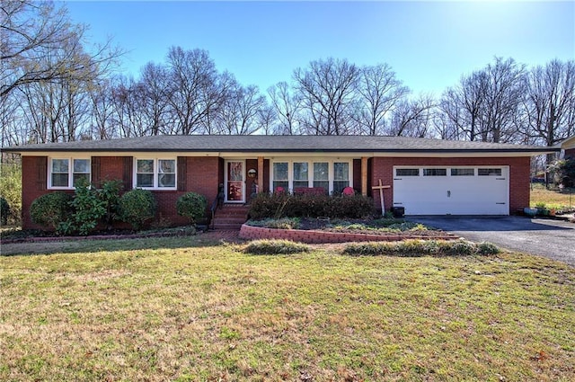 single story home with brick siding, aphalt driveway, a garage, and a front lawn