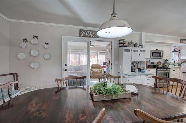 dining space with crown molding