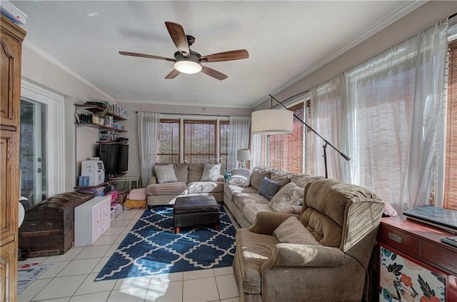 living room featuring a textured ceiling, light tile patterned floors, a ceiling fan, and ornamental molding