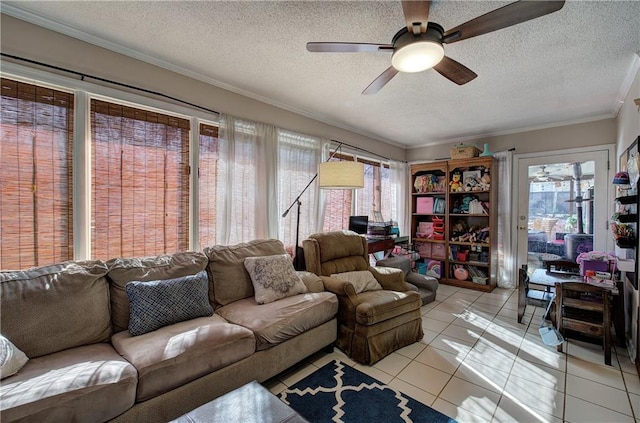 living room with light tile patterned floors, a textured ceiling, ornamental molding, and ceiling fan