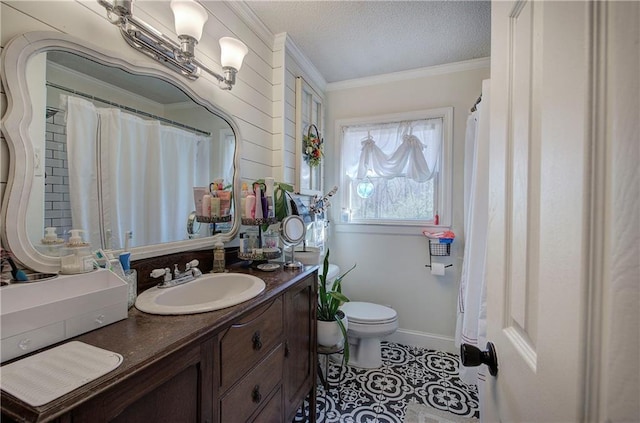 bathroom featuring vanity, a textured ceiling, crown molding, toilet, and tile patterned floors