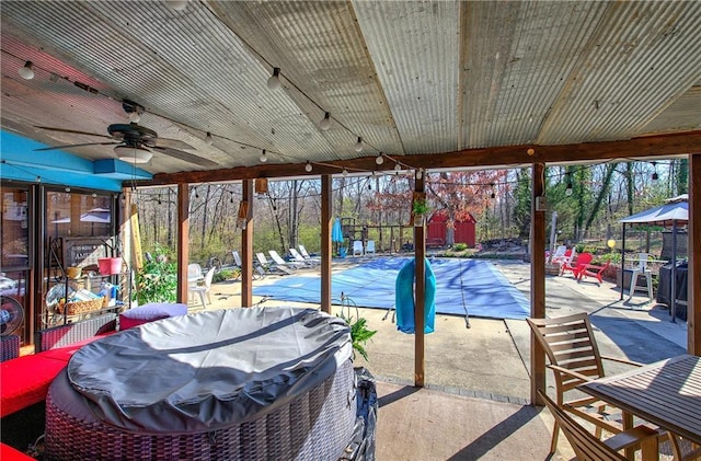 exterior space with a covered pool and ceiling fan