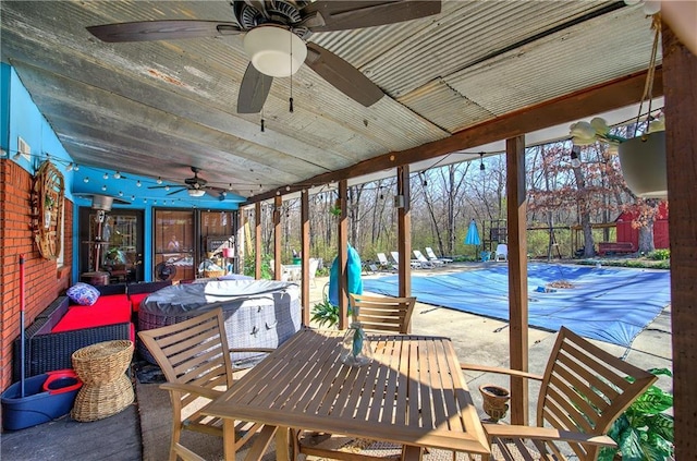 view of patio featuring a covered pool, outdoor dining area, and ceiling fan