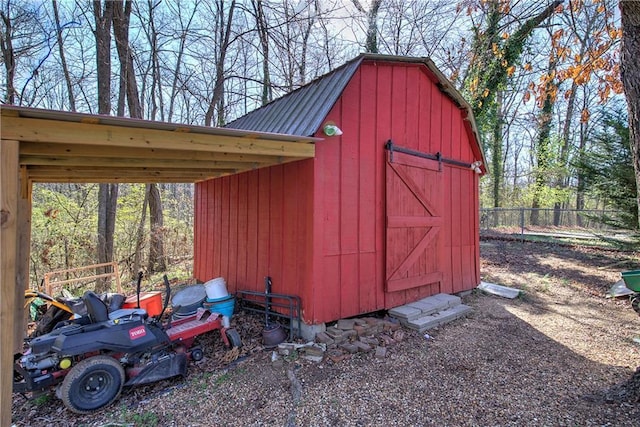 view of shed featuring fence