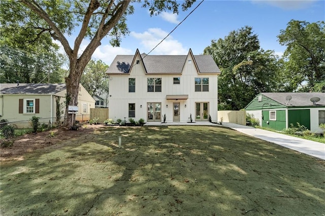 view of front of home featuring french doors and a front lawn