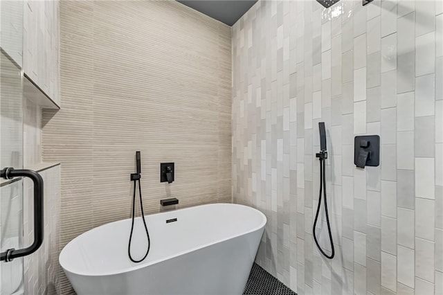 bathroom with a bathtub and tile walls