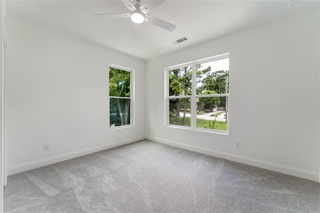 carpeted spare room featuring ceiling fan