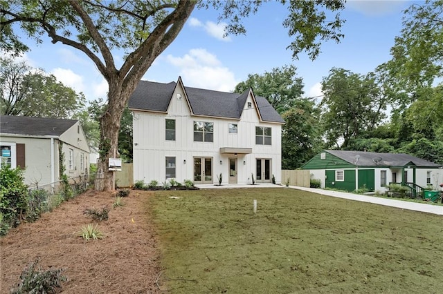 view of front facade featuring a patio, a front yard, and french doors