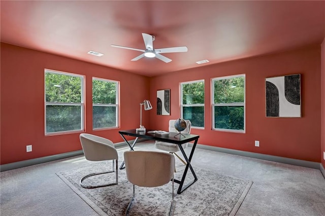 carpeted office featuring ceiling fan