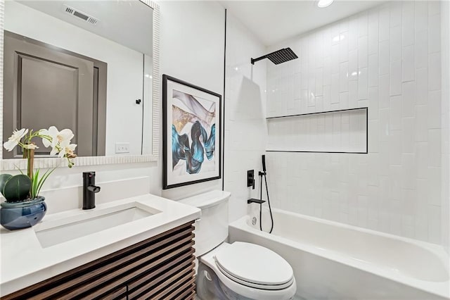 full bathroom with vanity, tiled shower / bath combo, and toilet